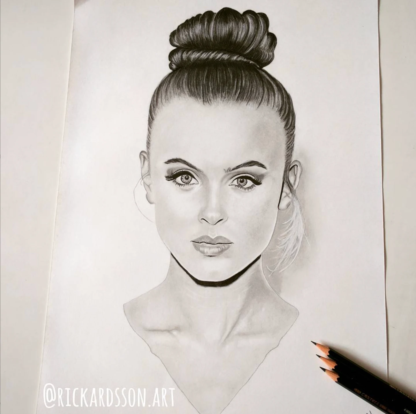 Monochrome portrait drawing of a woman with her hair in a high bun.