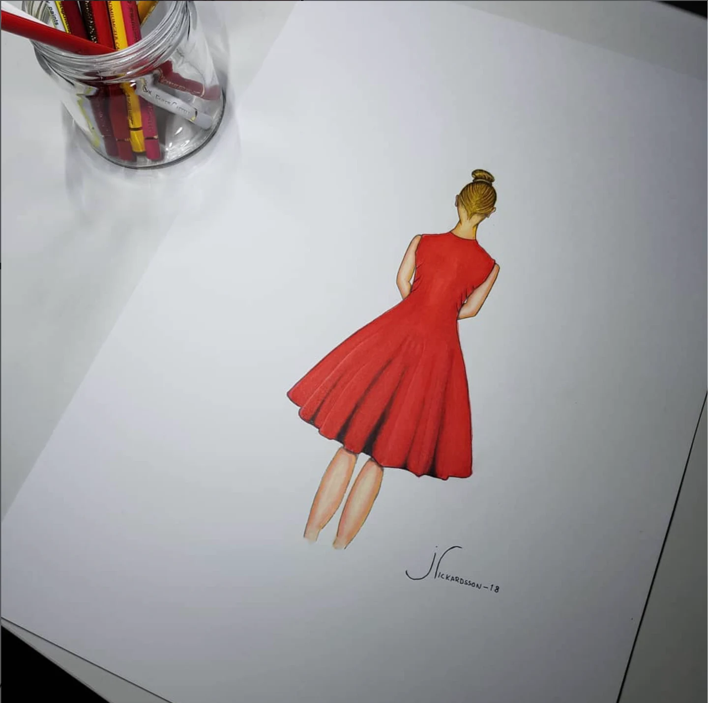 Drawing of a woman seen from behind in a flowing red dress, beside a jar of pencils.